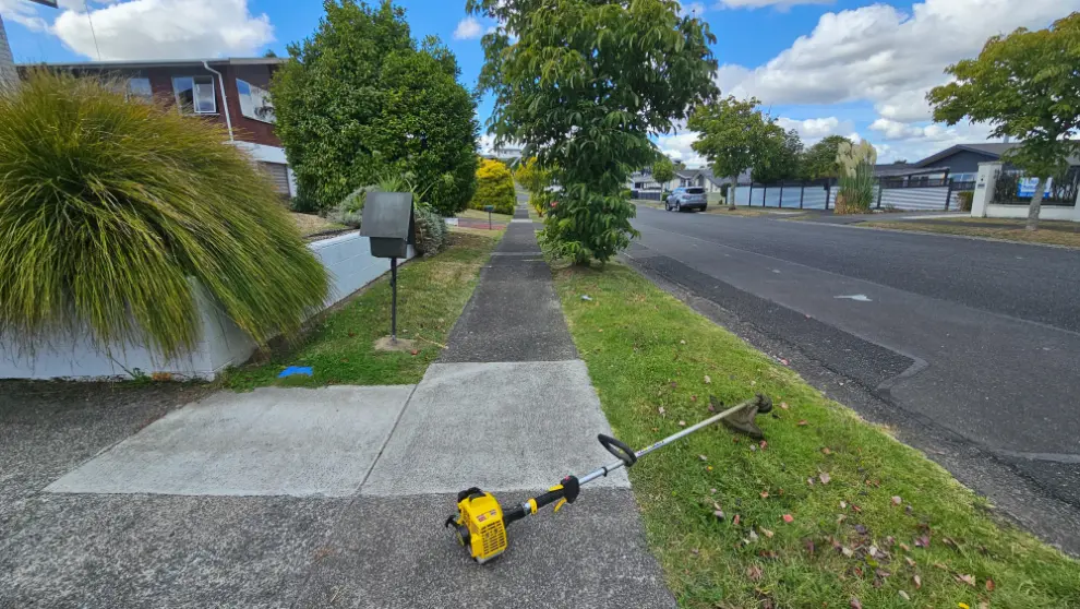 Lawn mowing equipment on a sidewalk